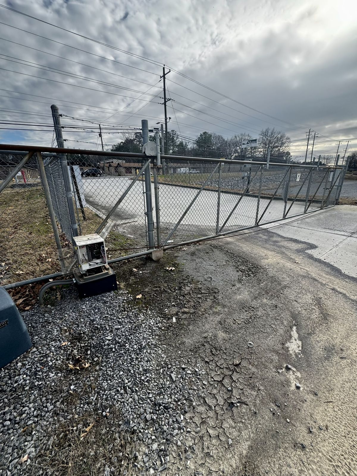 Commercial sliding chain-link gate with open operator control panel
